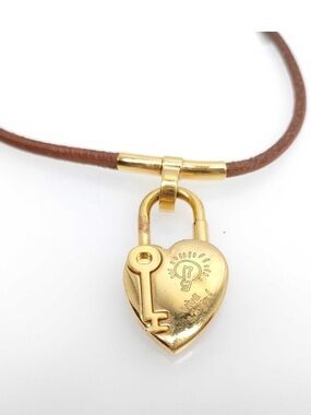 Hermès “Vive L’Idée” heart-shaped cadena padlock on brown leather cord choker